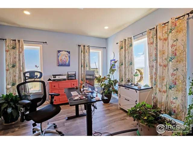 a bedroom with a bed lamps and a large mirror
