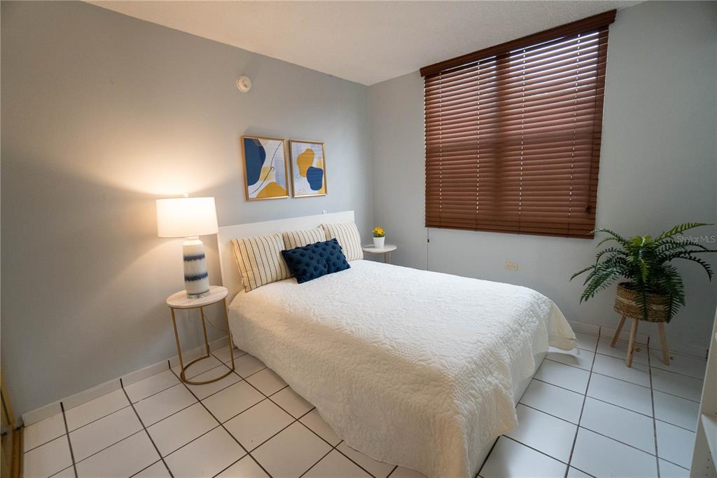 Cond Caparra Chalets Cond Caparra Chalets 8th, Unit 2A1 Guaynabo, PR 00966 - Photo 12 of 25 a bedroom with a bed and a potted plant