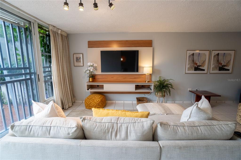 Cond Caparra Chalets Cond Caparra Chalets 8th, Unit 2A1 Guaynabo, PR 00966 - Photo 4 of 25 a living room with furniture and a flat screen tv