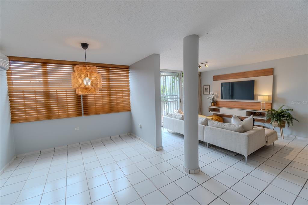 Cond Caparra Chalets Cond Caparra Chalets 8th, Unit 2A1 Guaynabo, PR 00966 - Photo 6 of 25 a living room with furniture and large windows