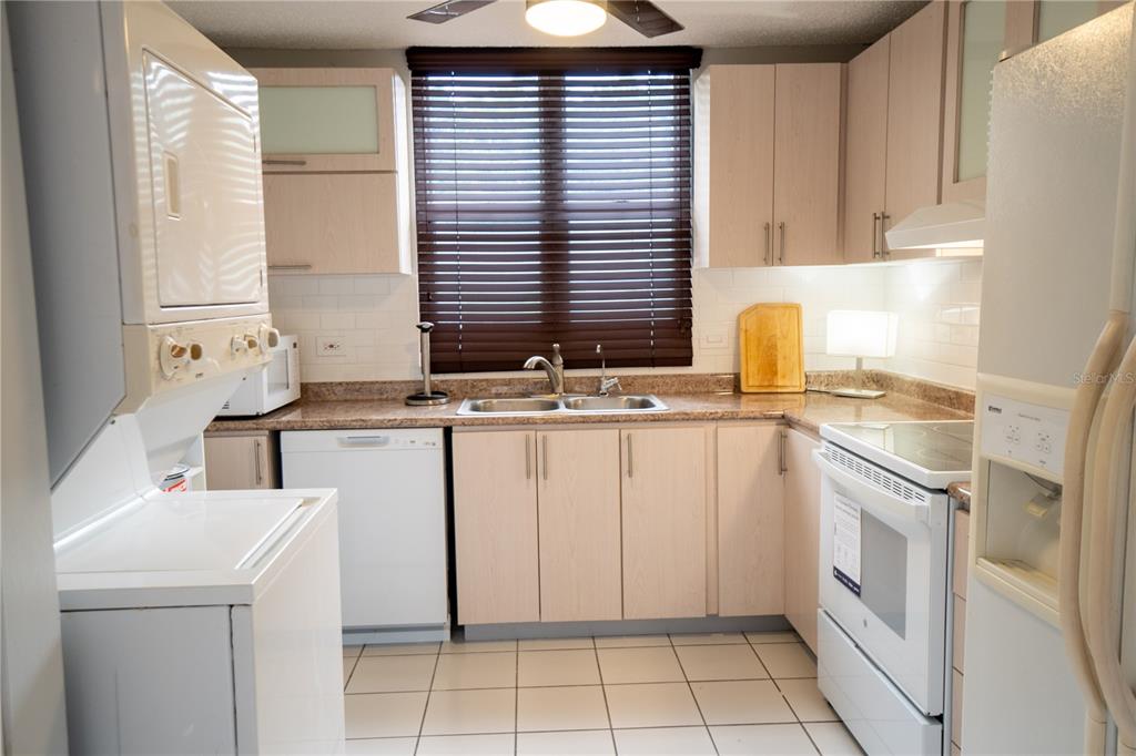 Cond Caparra Chalets Cond Caparra Chalets 8th, Unit 2A1 Guaynabo, PR 00966 - Photo 7 of 25 a kitchen with granite countertop a sink and a stove