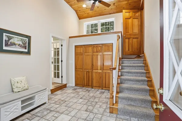 a view of a hallway with windows and entryway