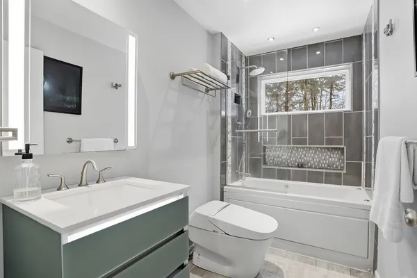 a bathroom with a sink toilet and shower