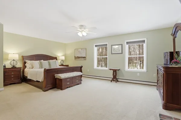 a spacious bedroom with a bed and a flat screen tv