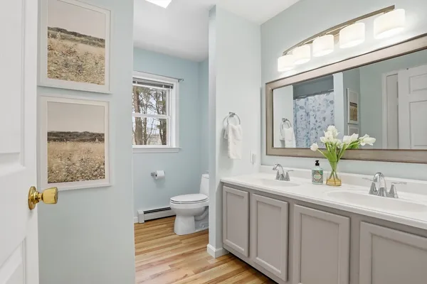 a bathroom with a toilet sink and mirror