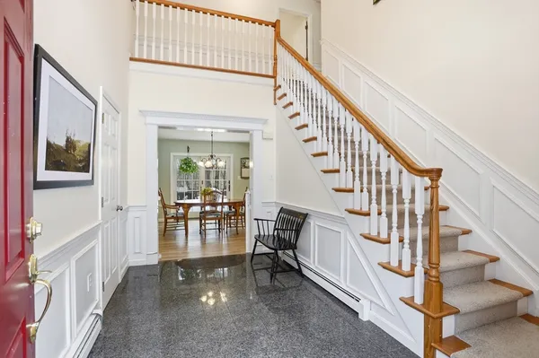 a view of entryway and hall with wooden floor