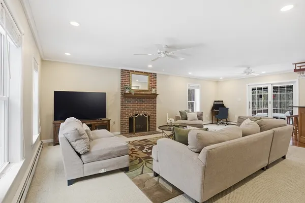 a living room with furniture fireplace and a flat screen tv