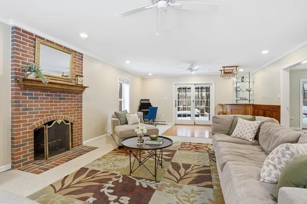 a living room with furniture flat screen tv and a fireplace