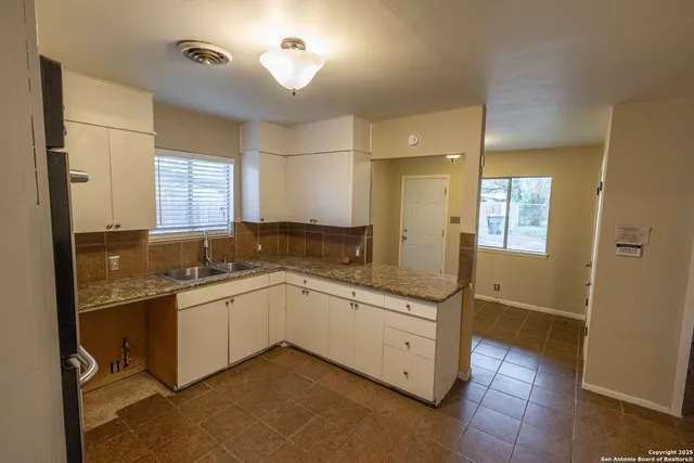 a kitchen with a sink stove and refrigerator
