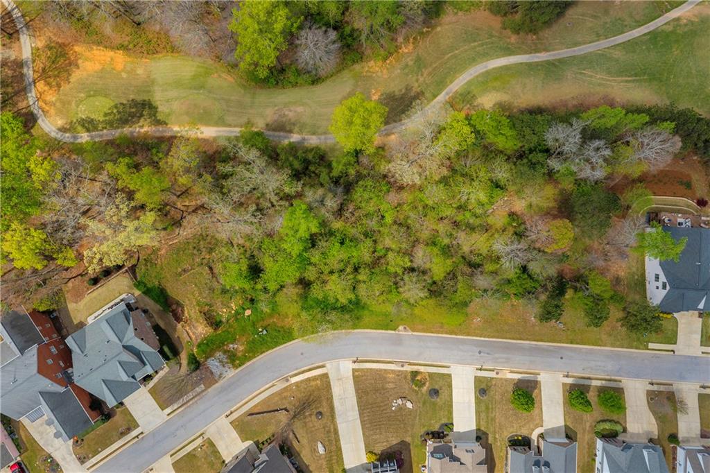 9131 Golfview Lane Covington, GA 30014 - Photo 11 of 19 a view of a blue swimming pool with a yard
