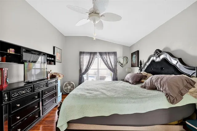 a bedroom with a bed and wooden floor