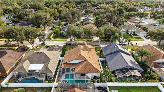 an aerial view of residential houses with yard and swimming pool
