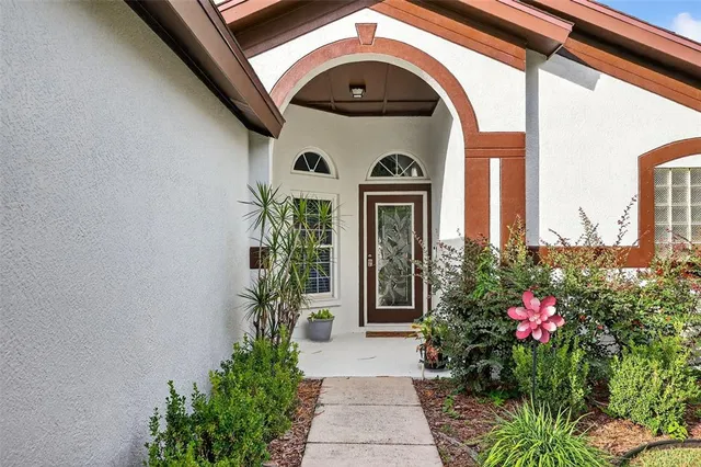 a front view of a house with plants