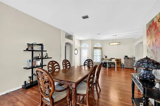 a view of a dining room with furniture and wooden floor