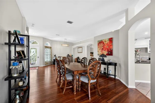 a view of a dining room with furniture and wooden floor