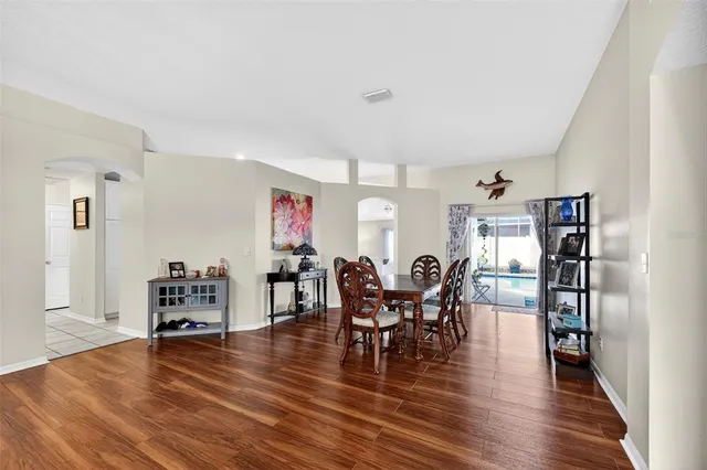 a view of a dining room with furniture and wooden floor