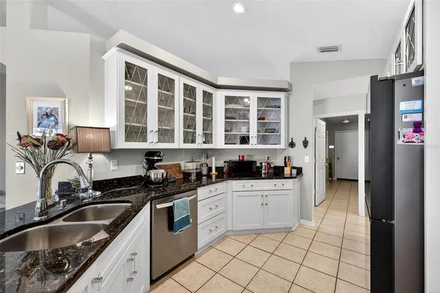 a kitchen with a sink stove top oven and refrigerator