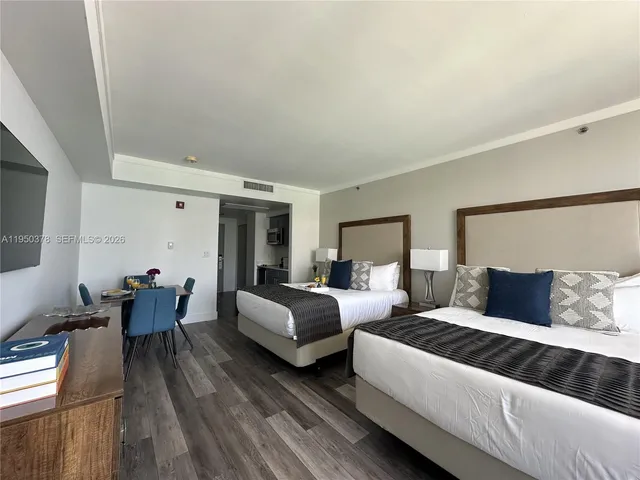 a bedroom with bed and wooden floor