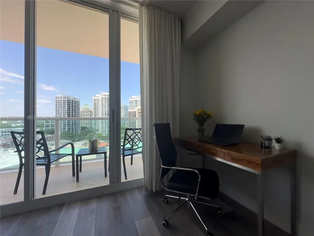 a view of a workspace with furniture and a gate