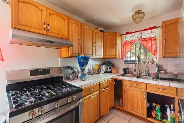 a kitchen with stainless steel appliances granite countertop a sink stove and cabinets