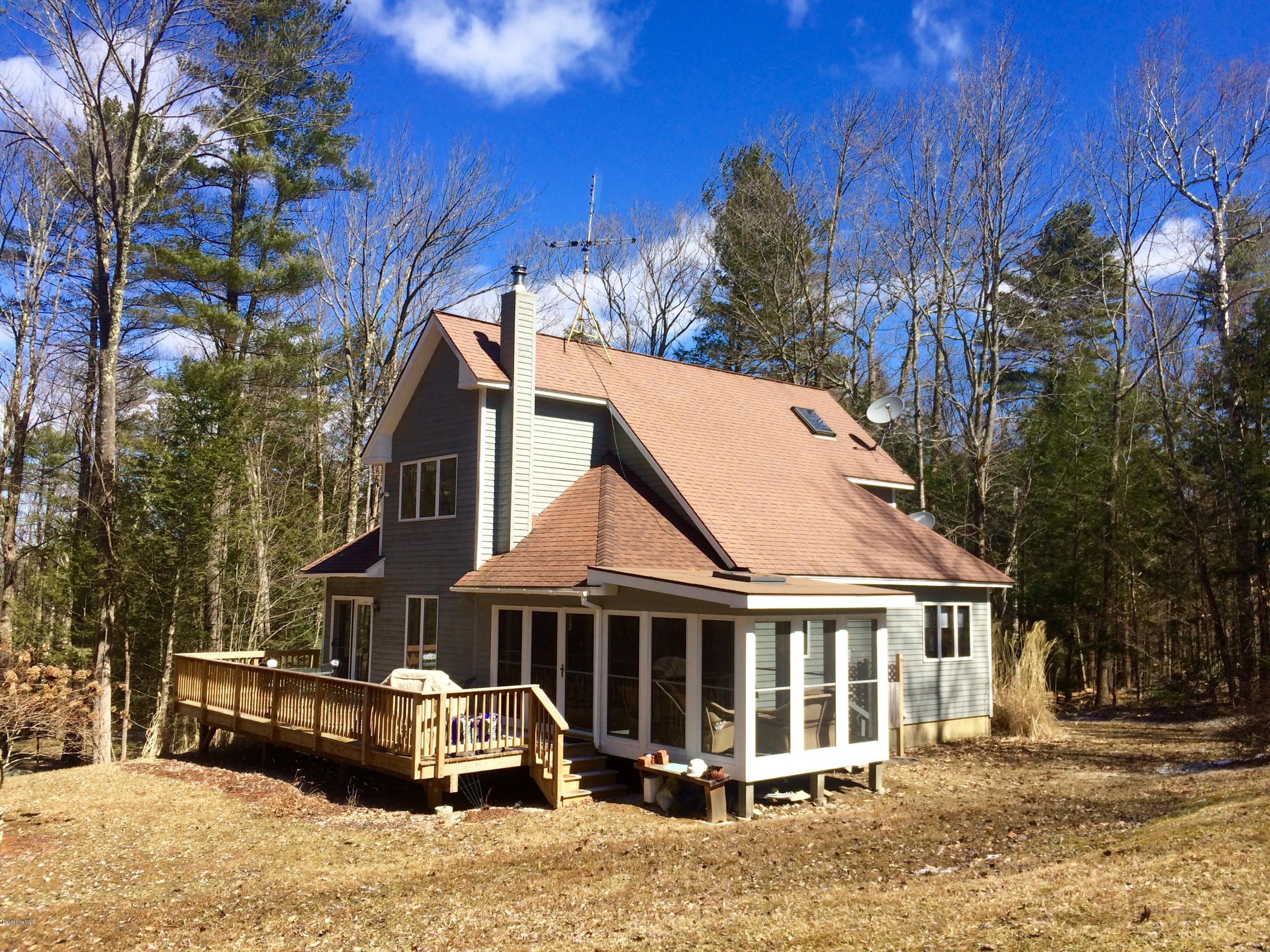 64 Monterey Road Tyringham, MA 01264 - Photo 2 of 26 a front view of a house with a yard