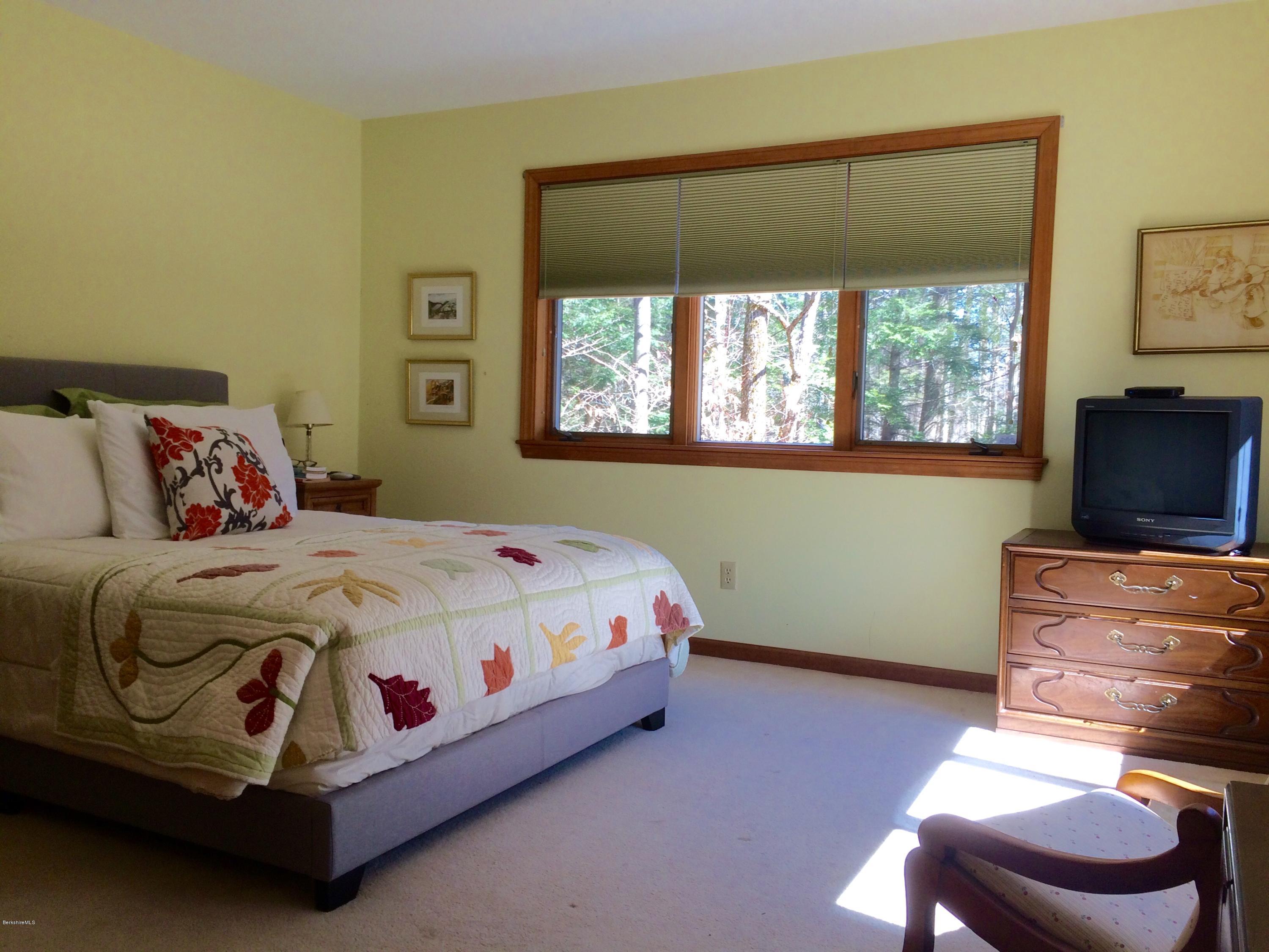 64 Monterey Road Tyringham, MA 01264 - Photo 17 of 26 a bedroom with a bed and a window
