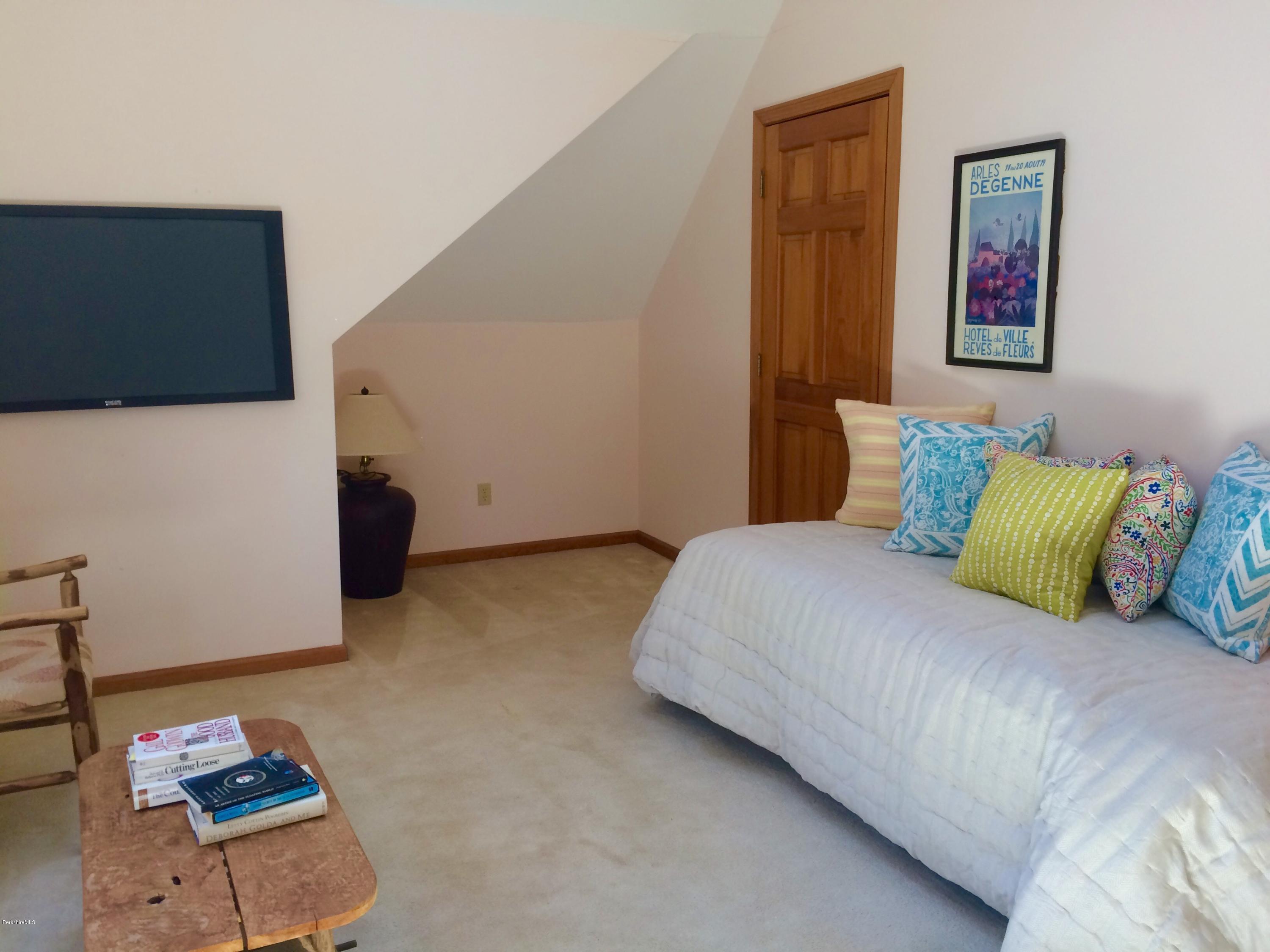 64 Monterey Road Tyringham, MA 01264 - Photo 23 of 26 a bedroom with a bed and cabinets
