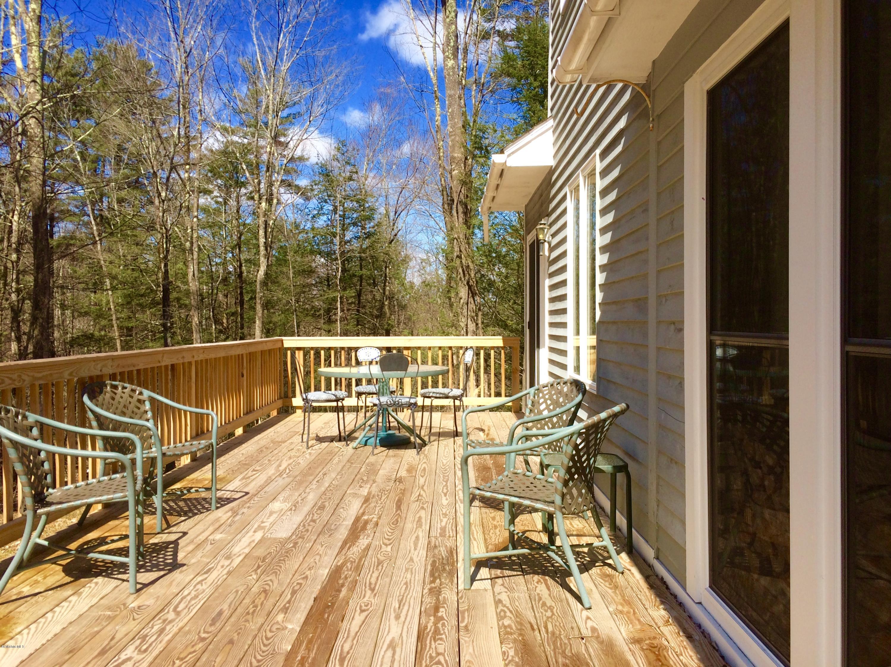 64 Monterey Road Tyringham, MA 01264 - Photo 25 of 26 a view of a balcony with two chairs and wooden floor