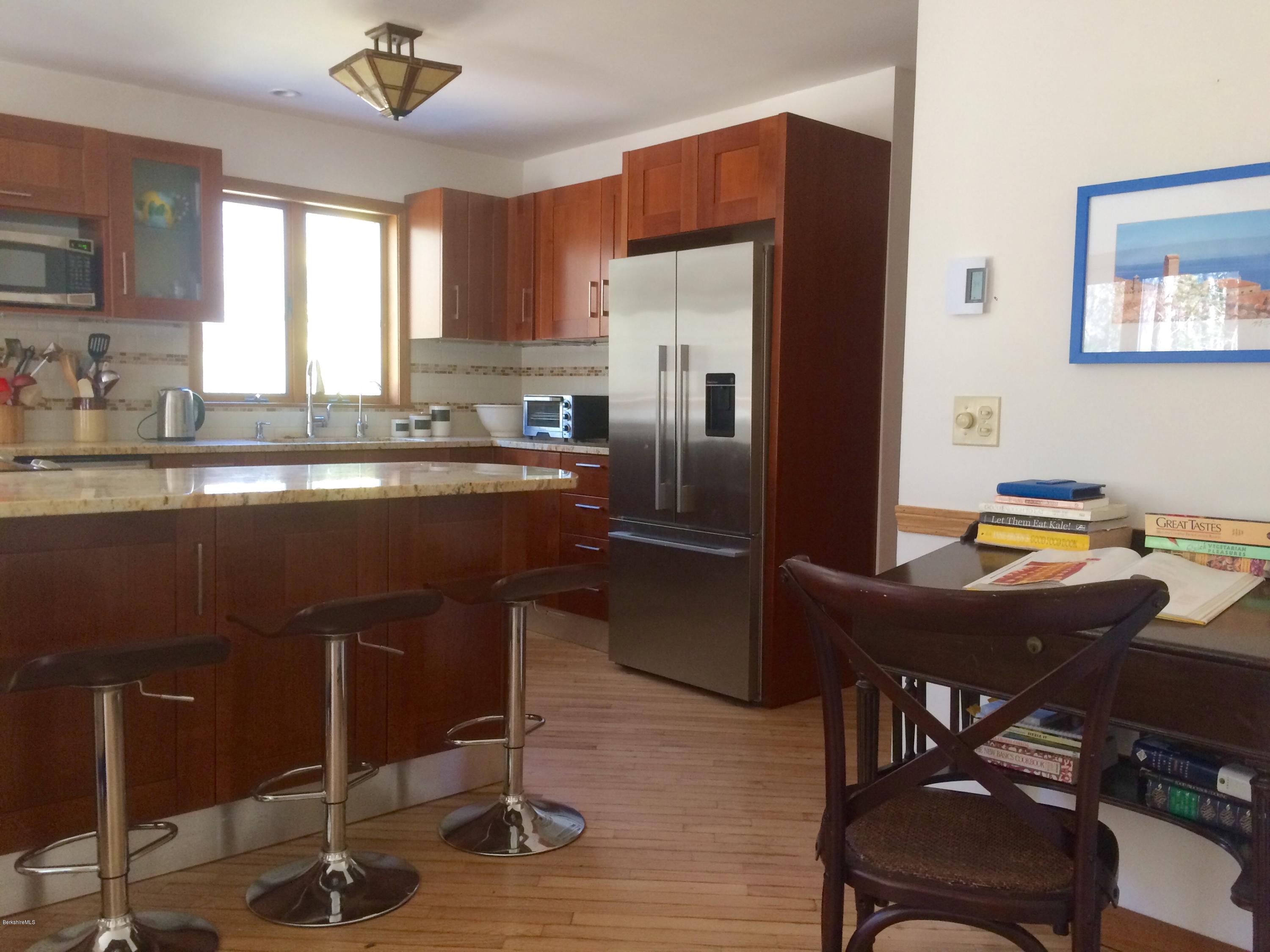 64 Monterey Road Tyringham, MA 01264 - Photo 8 of 26 a kitchen with a table chairs refrigerator and cabinets