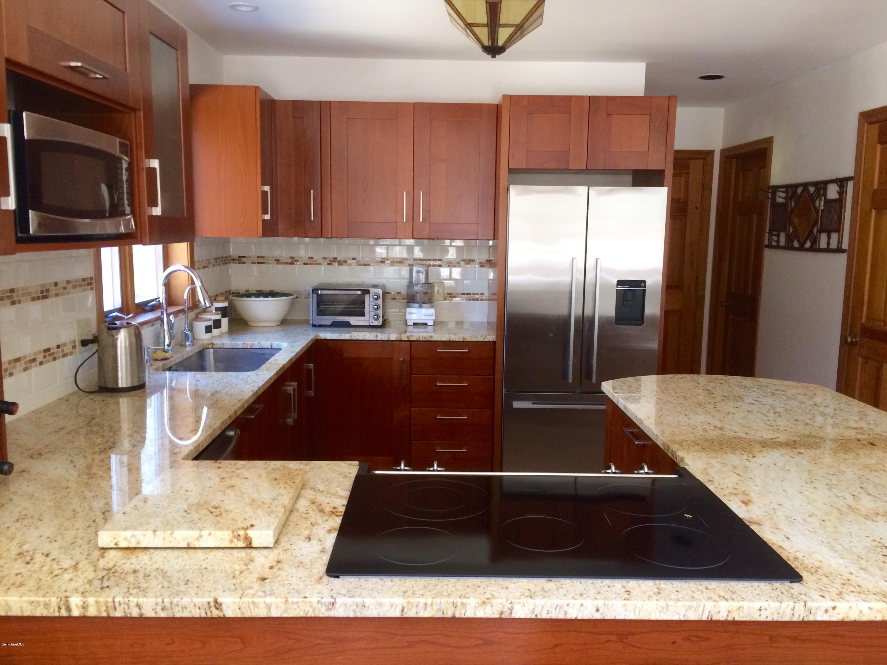 64 Monterey Road Tyringham, MA 01264 - Photo 9 of 26 a kitchen with a refrigerator and a sink