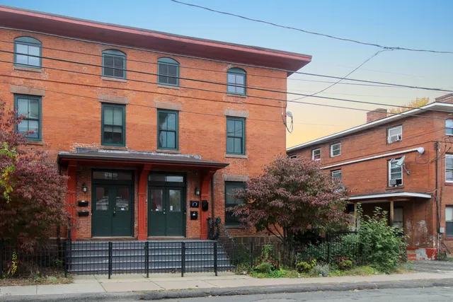 a view of a brick building with large windows