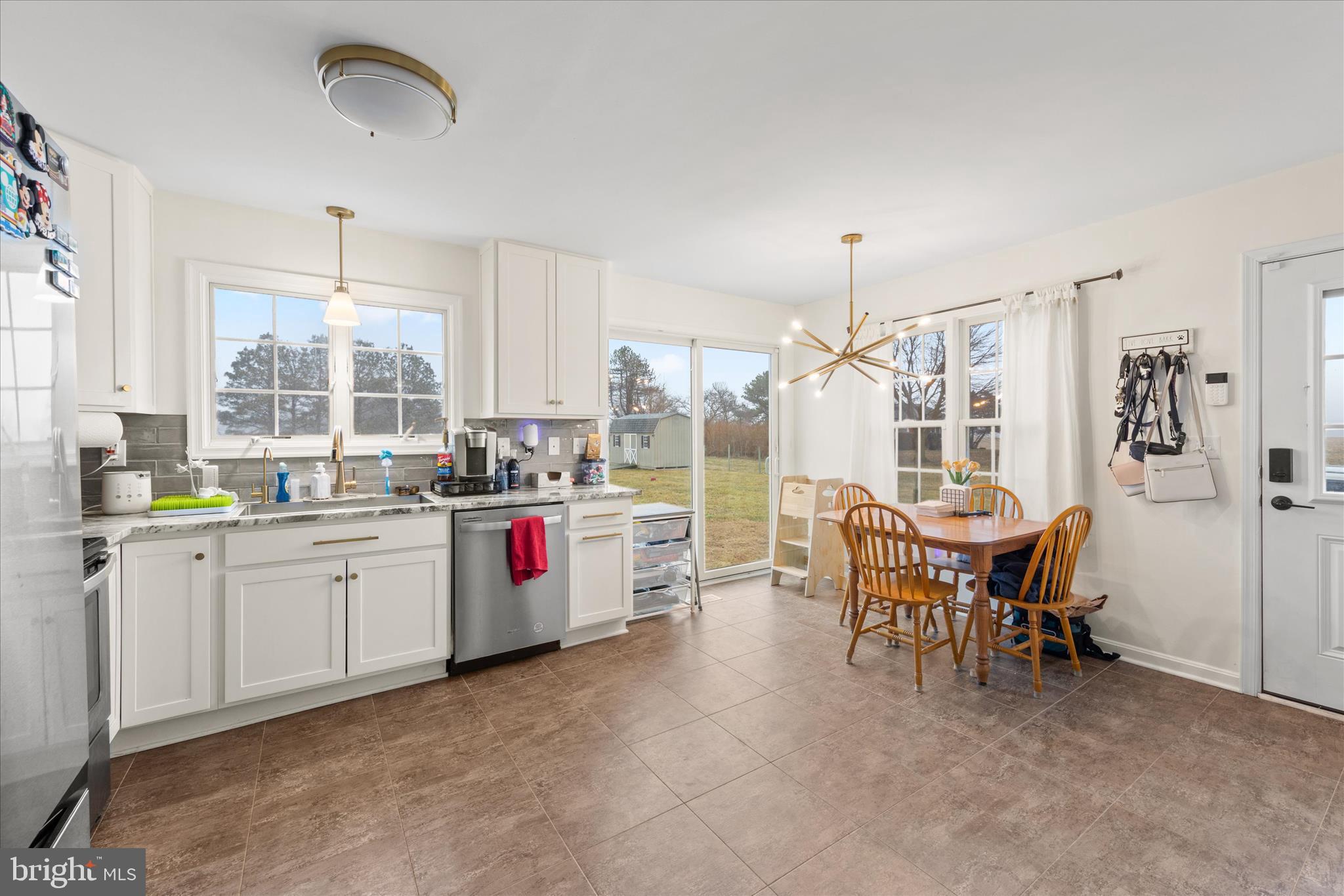 1807 Price Station Road Church Hill, MD 21623 - Photo 14 of 48 a kitchen with refrigerator cabinets table and chairs