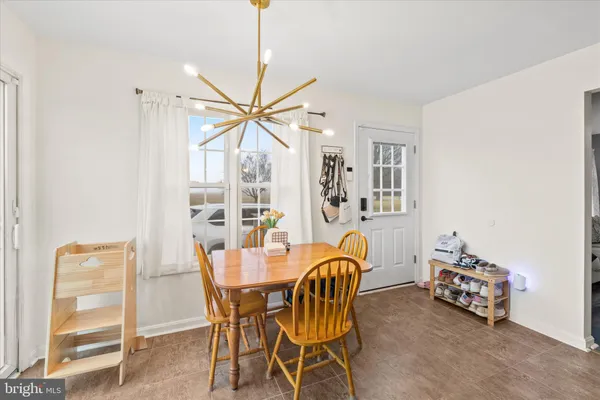 a dining room with furniture and window