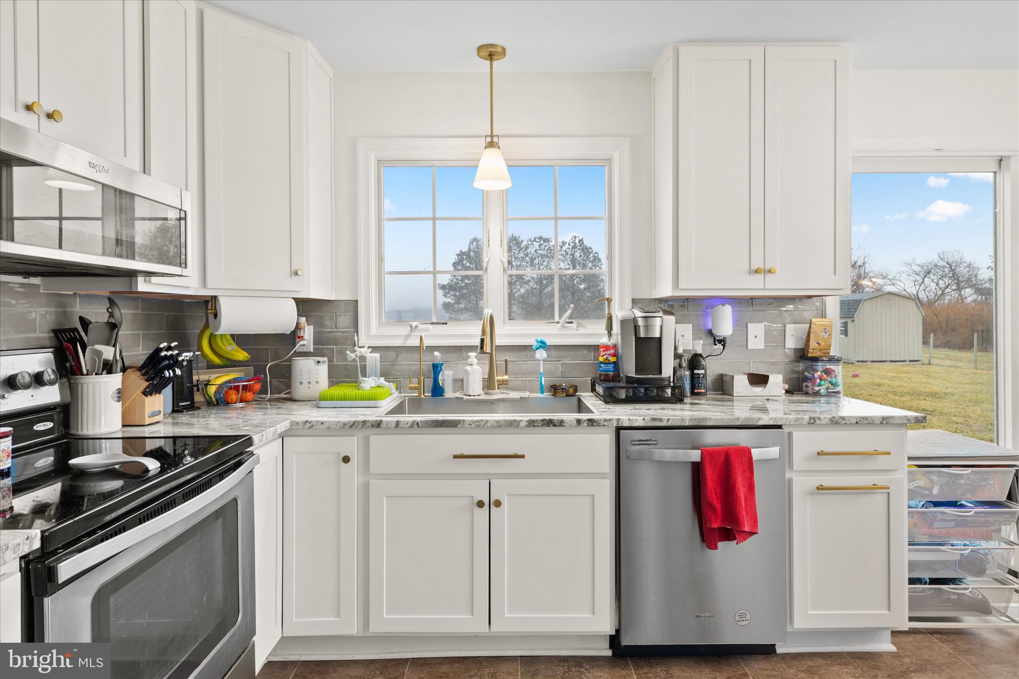 1807 Price Station Road Church Hill, MD 21623 - Photo 19 of 48 a kitchen with kitchen island granite countertop a sink stainless steel appliances and white cabinets