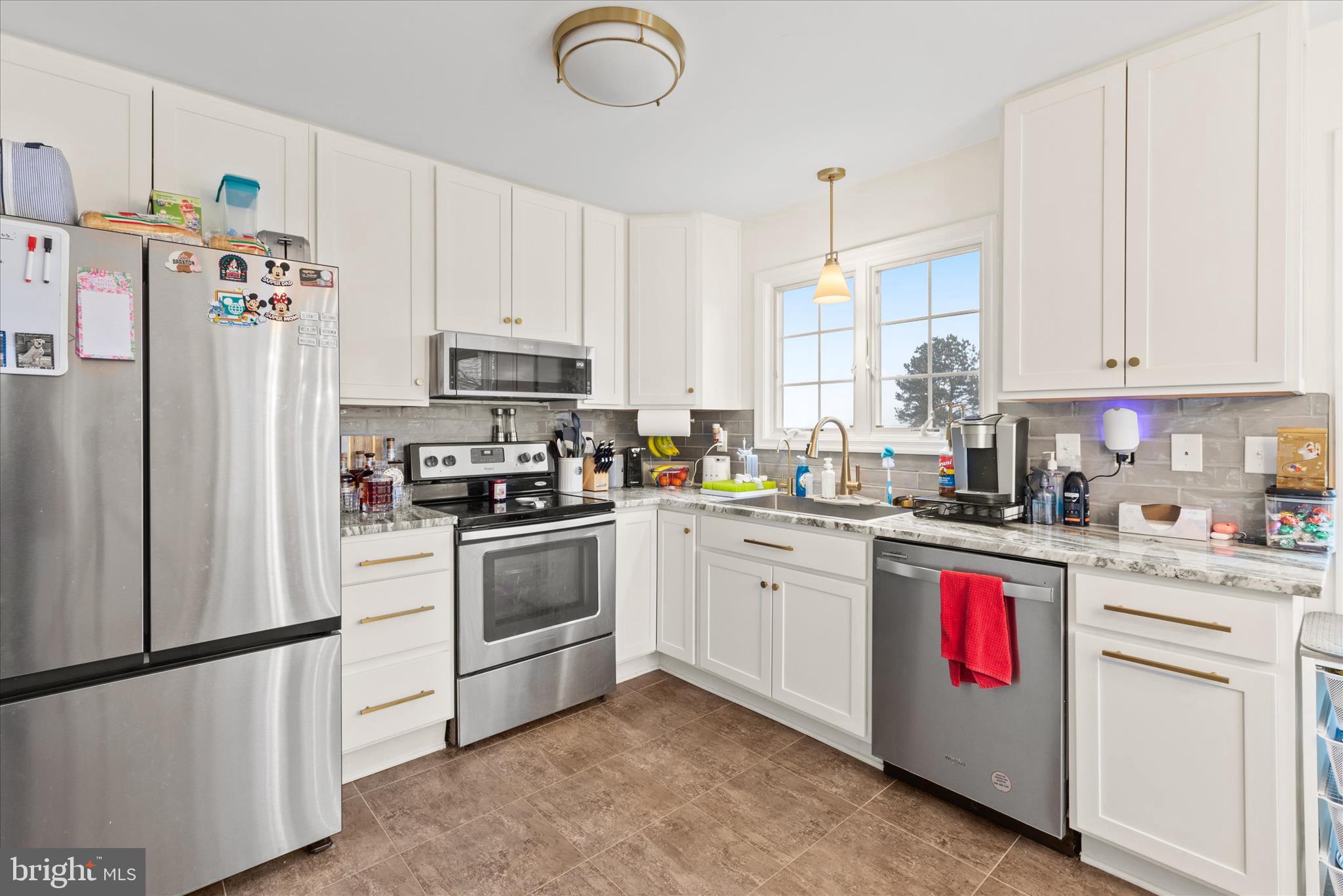 1807 Price Station Road Church Hill, MD 21623 - Photo 21 of 48 a kitchen with stainless steel appliances granite countertop a refrigerator sink stove and white cabinets