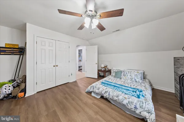 a bedroom with bed and a bookshelf