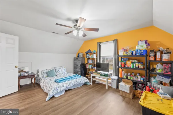 a bedroom with a large bed and a flat screen tv