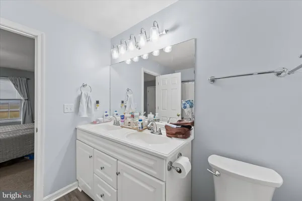 a white toilet sitting next to a bathroom sink