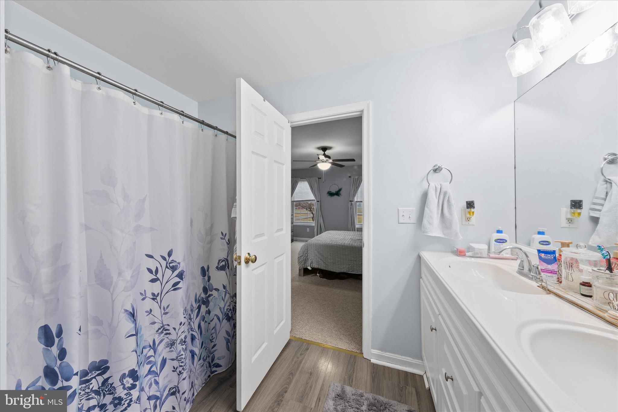 1807 Price Station Road Church Hill, MD 21623 - Photo 39 of 48 a en suite bathroom with a sink a large mirror and shower view