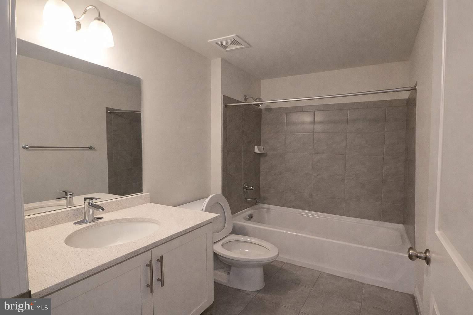 8706 Cherrybark Road Clinton, MD 20735 - Photo 12 of 21 a bathroom with a toilet a sink and a bathtub