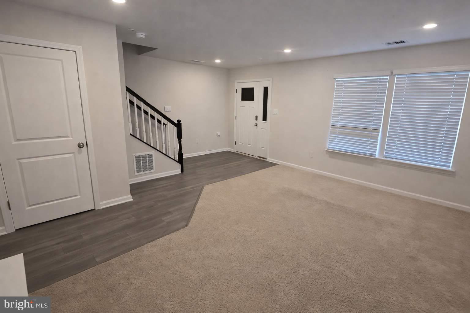 8706 Cherrybark Road Clinton, MD 20735 - Photo 2 of 21 a view of an empty room with wooden floor and stairs
