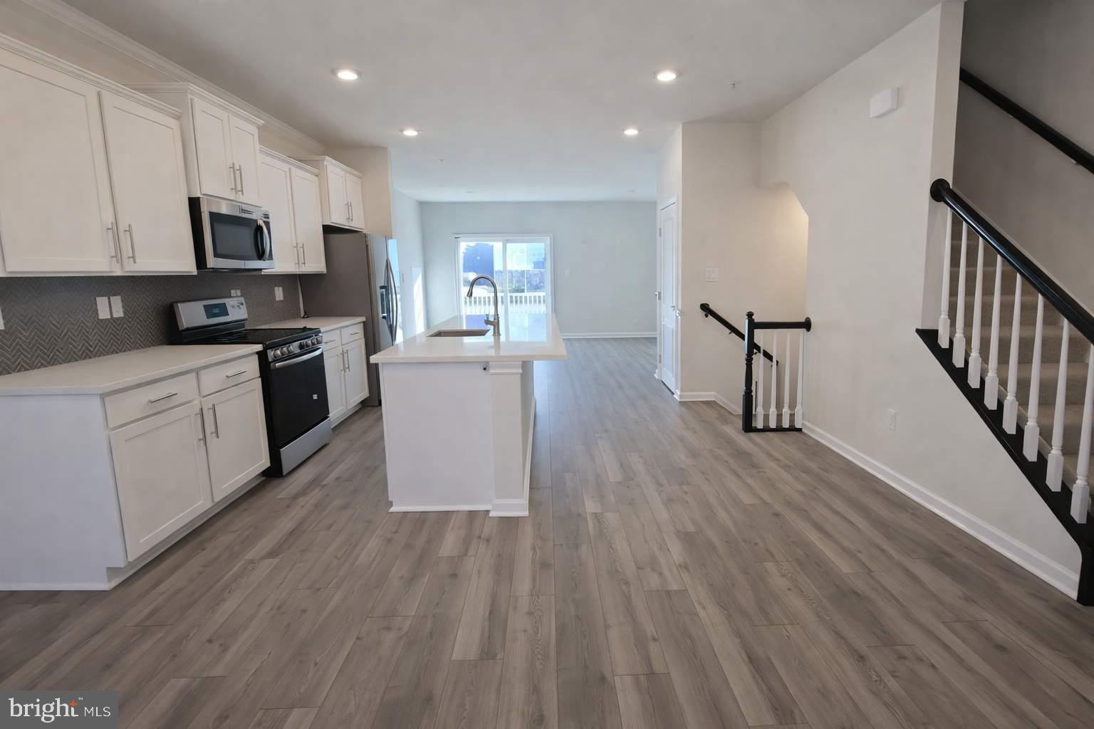 8706 Cherrybark Road Clinton, MD 20735 - Photo 5 of 21 a kitchen with cabinets a sink and wooden floor
