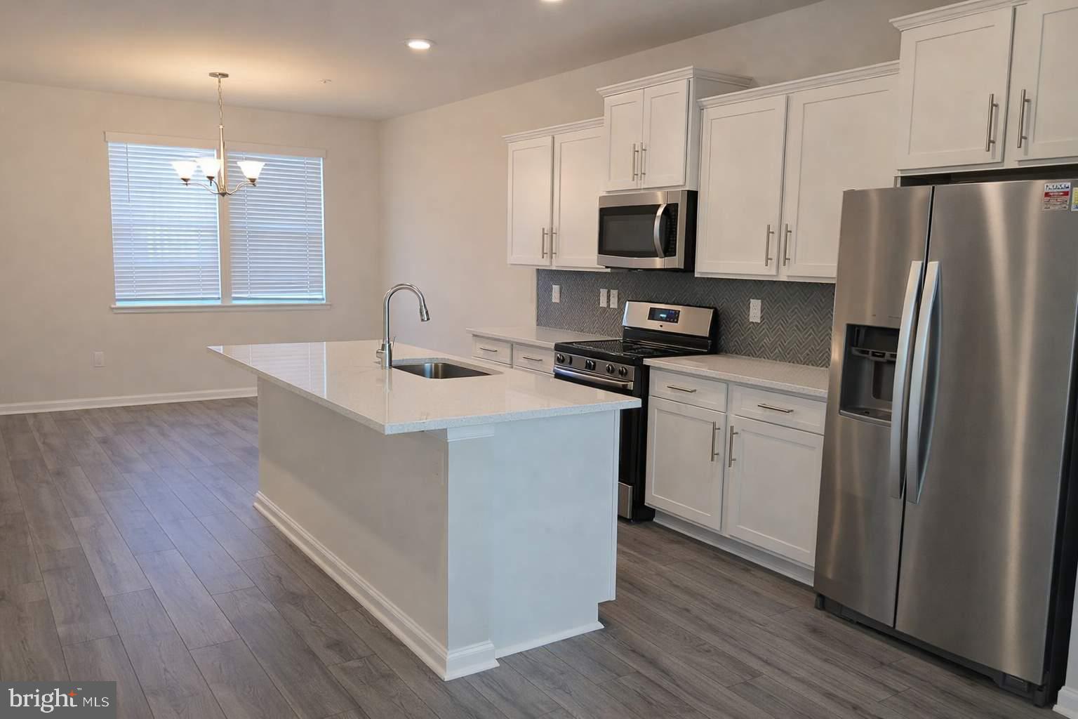 8706 Cherrybark Road Clinton, MD 20735 - Photo 6 of 21 a kitchen with stainless steel appliances a refrigerator stove microwave and sink