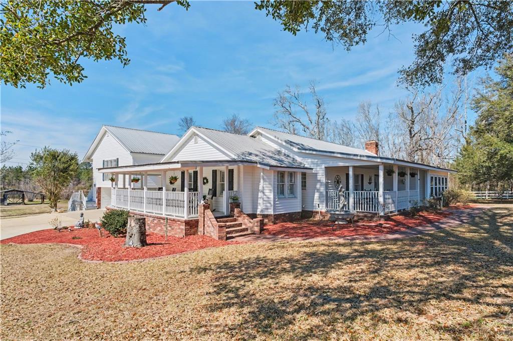1833 Tom Odum Road Vidalia, GA 30474 - Photo 3 of 59 a view of a house with wooden deck and a big yard