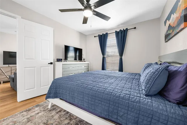 a bedroom with a bed and a flat screen tv