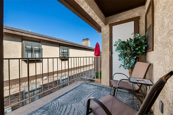 a view of a balcony with furniture