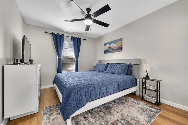 a bedroom with a bed and a large mirror