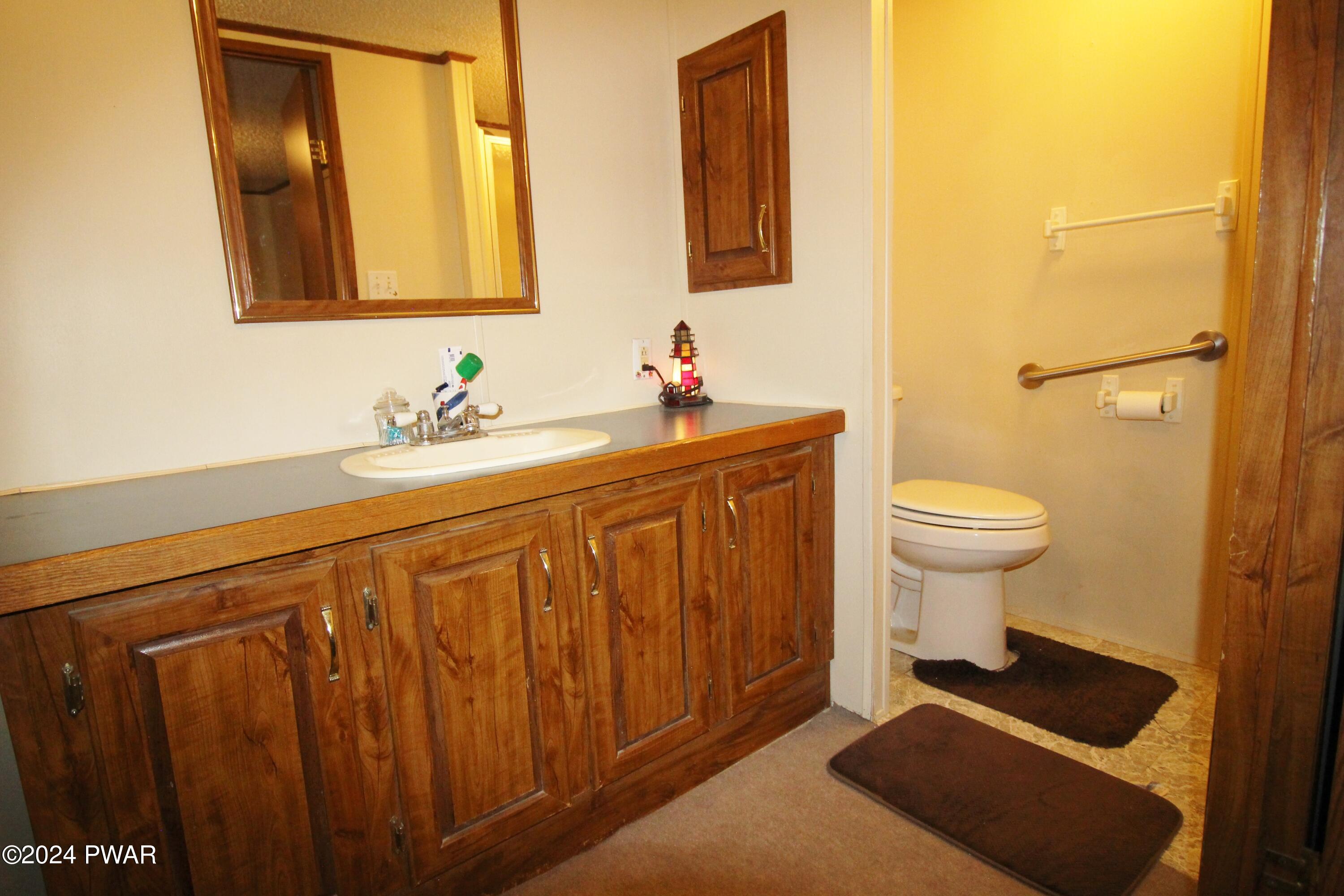 10 Madison Estate Moscow, PA 18444 - Photo 27 of 45 a bathroom with a sink a toilet and a mirror