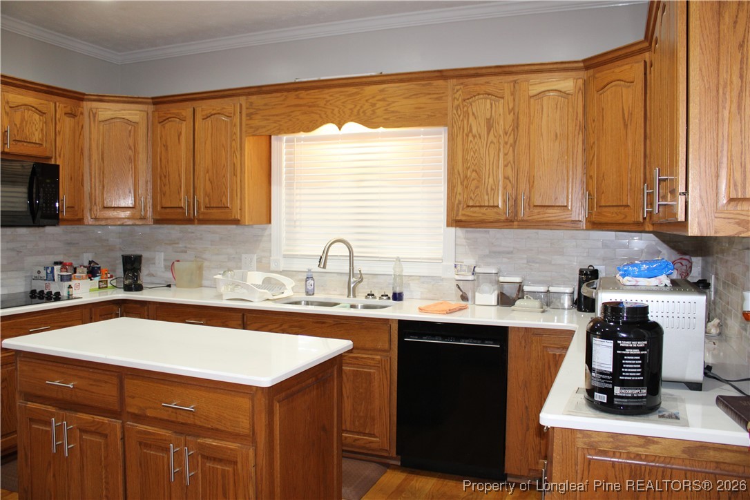 573 Porter Road Hope Mills, NC 28348 - Photo 7 of 29 a kitchen with stainless steel appliances granite countertop a sink stove and cabinets