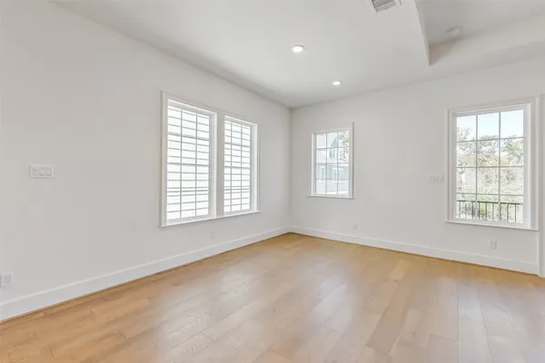 a view of a house with wooden floor next to a yard